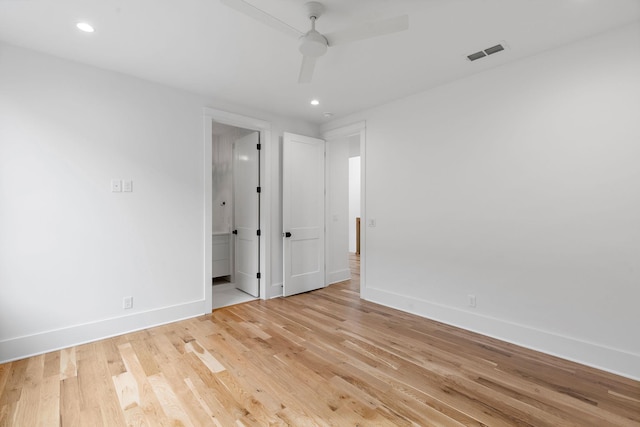 unfurnished bedroom featuring baseboards, visible vents, recessed lighting, light wood-type flooring, and connected bathroom