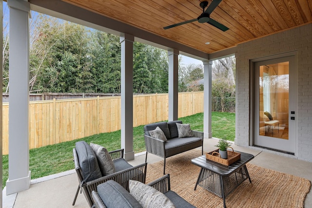 sunroom with ceiling fan and wooden ceiling