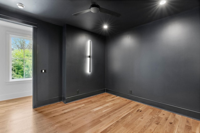 spare room featuring a ceiling fan, recessed lighting, baseboards, and light wood finished floors