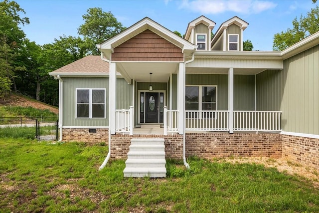 view of front of property featuring a porch, board and batten siding, and a shingled roof
