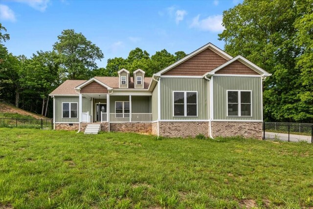 rear view of property with board and batten siding and a porch