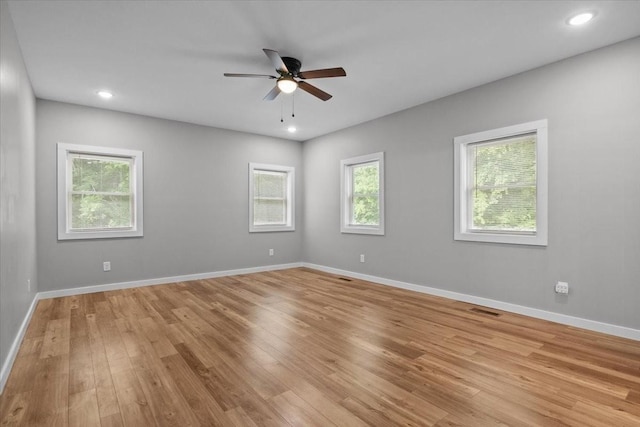 spare room with light wood-style flooring, ceiling fan, baseboards, and recessed lighting