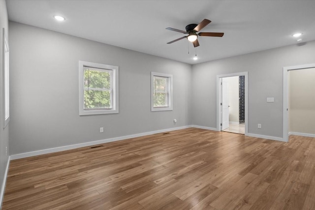 unfurnished bedroom featuring light wood-style flooring, recessed lighting, ensuite bath, baseboards, and ceiling fan