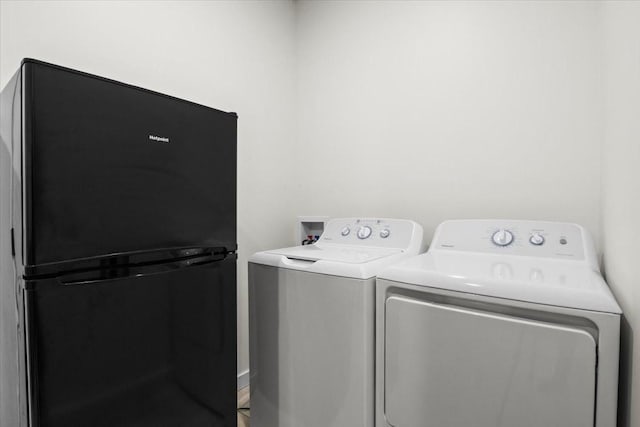 clothes washing area with washer and clothes dryer