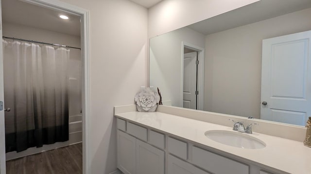 bathroom featuring recessed lighting, wood finished floors, and vanity