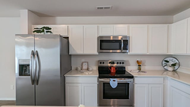 kitchen with visible vents, white cabinets, appliances with stainless steel finishes, and light countertops