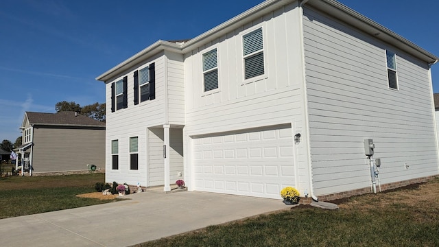 view of side of property featuring a garage, board and batten siding, driveway, and a yard