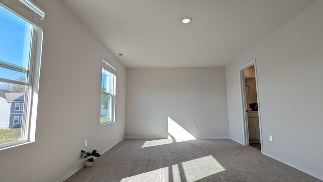 carpeted empty room with visible vents and baseboards