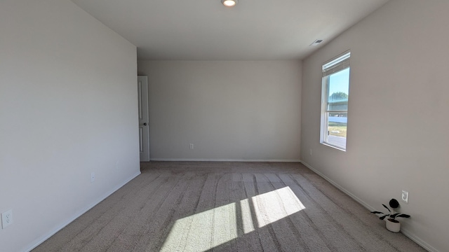 unfurnished room featuring recessed lighting, visible vents, baseboards, and carpet