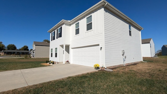 view of home's exterior with driveway, a lawn, board and batten siding, and an attached garage