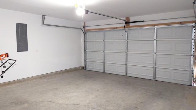 garage featuring electric panel and baseboards