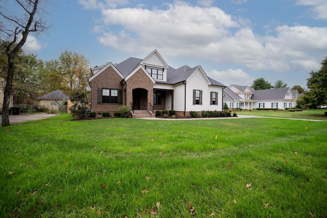 view of front of property featuring brick siding and a front yard