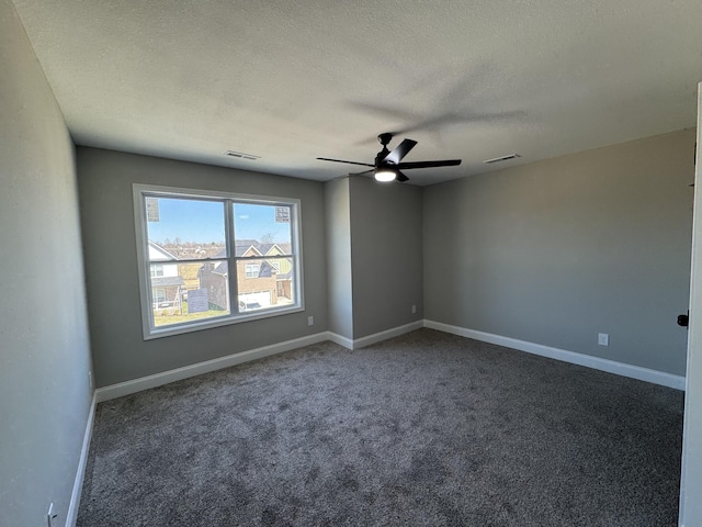 carpeted spare room featuring visible vents, ceiling fan, a textured ceiling, and baseboards