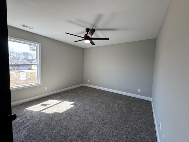 empty room featuring visible vents, baseboards, carpet, and a ceiling fan