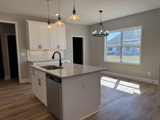 kitchen with decorative backsplash, stainless steel dishwasher, dark wood-style floors, white cabinets, and a sink