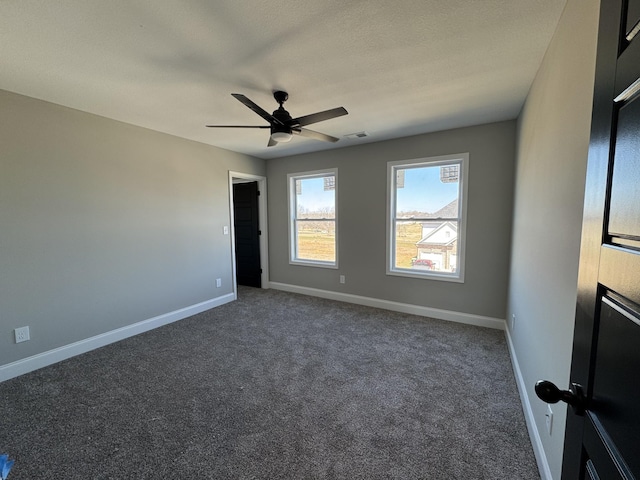 unfurnished bedroom featuring baseboards, carpet floors, visible vents, and ceiling fan