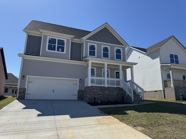 view of front of home with covered porch, board and batten siding, an attached garage, and driveway