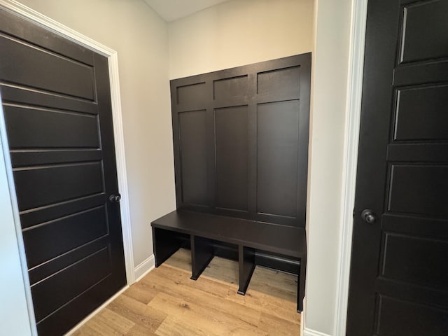 mudroom featuring baseboards and light wood finished floors