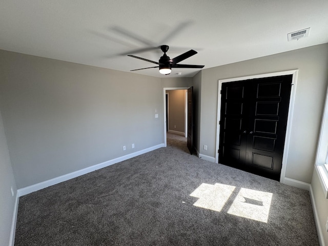 unfurnished bedroom featuring visible vents, baseboards, carpet floors, and a ceiling fan