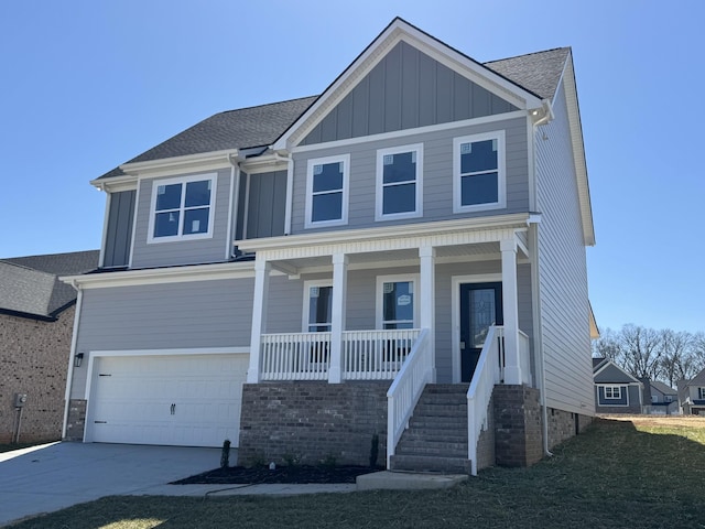 view of front facade featuring an attached garage, covered porch, a shingled roof, concrete driveway, and board and batten siding