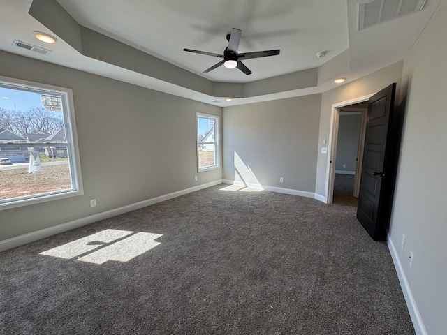 spare room with visible vents, carpet floors, and baseboards