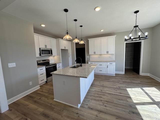 kitchen featuring tasteful backsplash, white cabinets, stainless steel appliances, and a sink