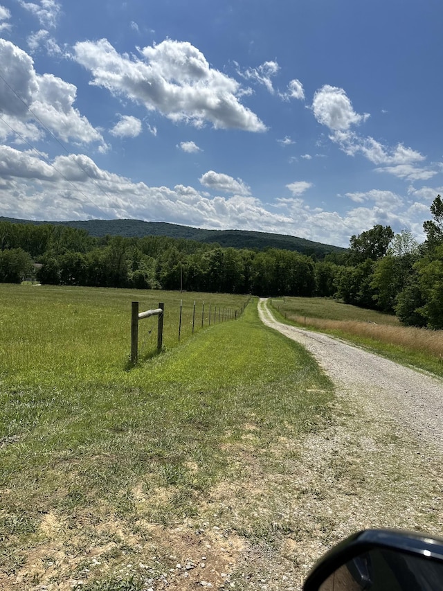 view of street featuring a rural view and a forest view