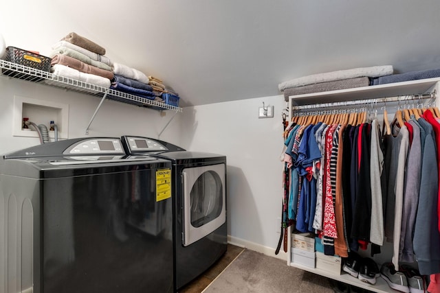 laundry room with laundry area, baseboards, and washer and clothes dryer