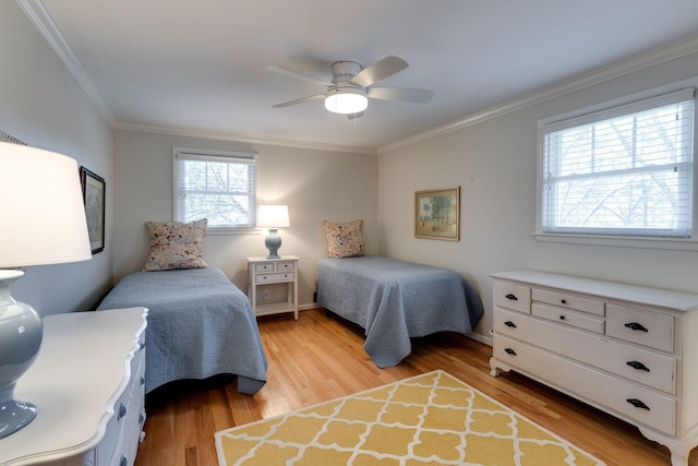 bedroom featuring light wood finished floors, baseboards, a ceiling fan, and ornamental molding