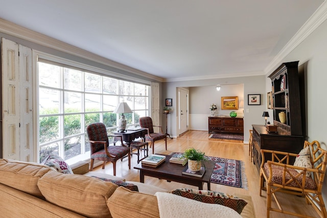 living area with light wood finished floors and ornamental molding