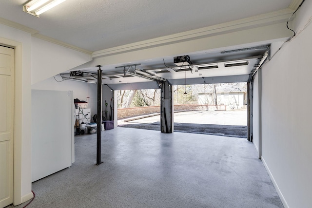 garage featuring freestanding refrigerator and baseboards