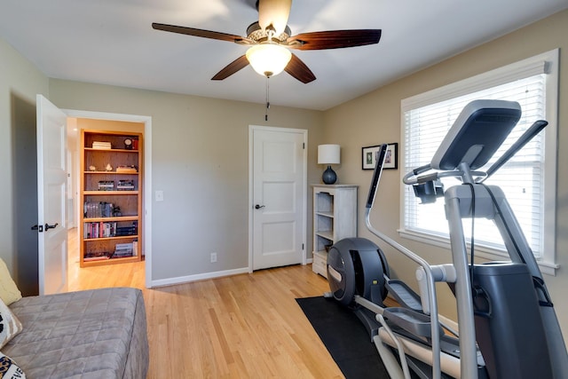 exercise area with plenty of natural light, ceiling fan, baseboards, and light wood-style floors