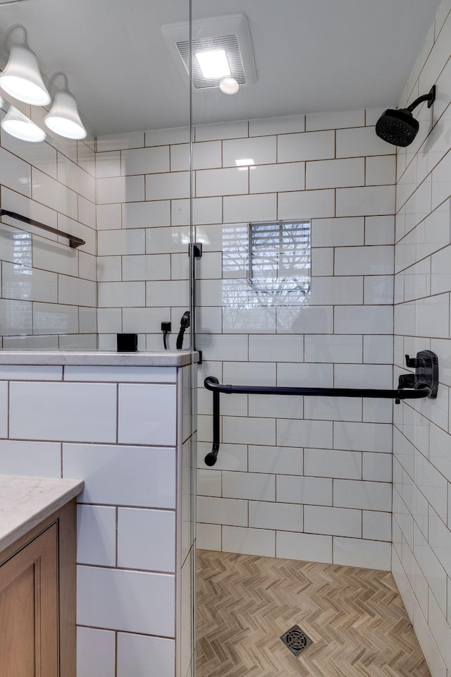 bathroom with visible vents and tiled shower