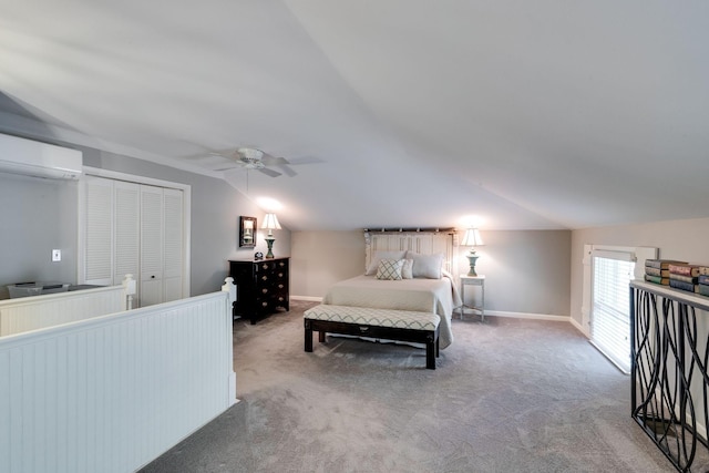 bedroom with baseboards, a wall mounted air conditioner, carpet, and lofted ceiling