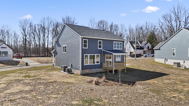 back of house with central AC unit