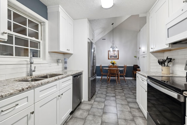 kitchen with a sink, white cabinetry, and stainless steel appliances