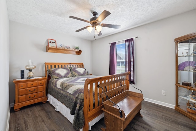 bedroom featuring ceiling fan, dark wood-style floors, baseboards, and a textured ceiling