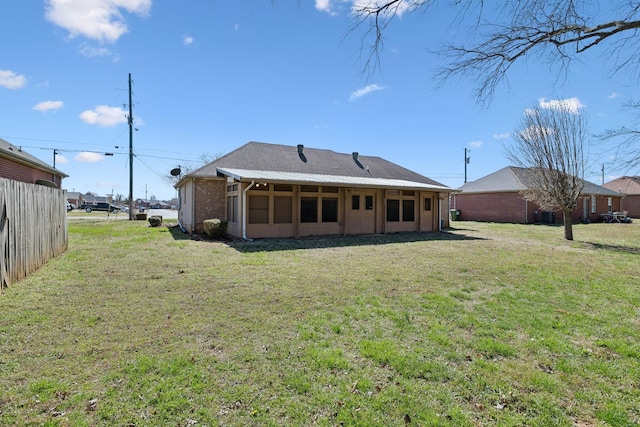 back of house with a yard and fence