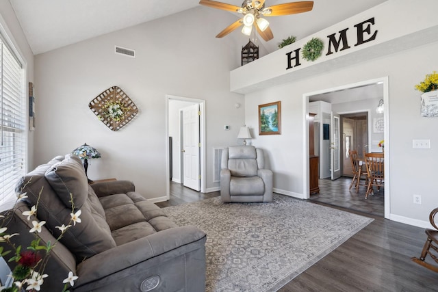 living area with visible vents, baseboards, dark wood-style floors, and a ceiling fan