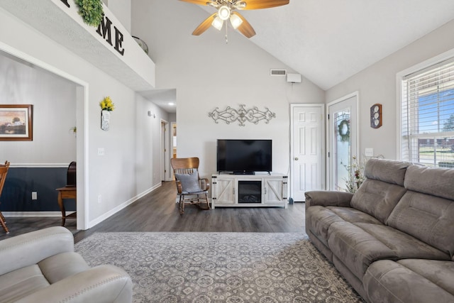 living room with ceiling fan, baseboards, high vaulted ceiling, and wood finished floors