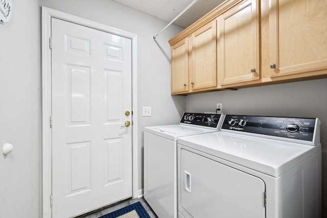 washroom with cabinet space and independent washer and dryer