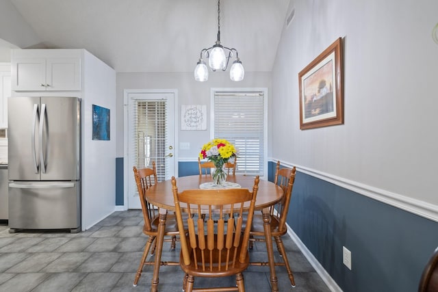 dining room with vaulted ceiling and visible vents