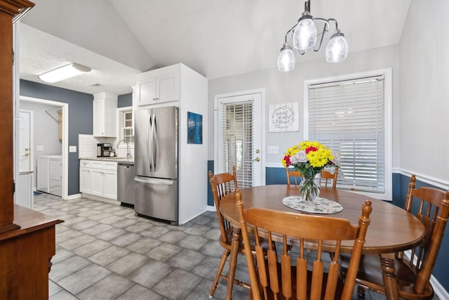 dining space featuring vaulted ceiling