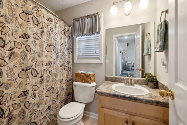 bathroom featuring baseboards, toilet, vanity, a shower with curtain, and a textured ceiling