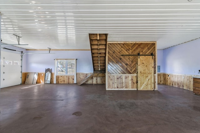 garage with wooden walls and wainscoting