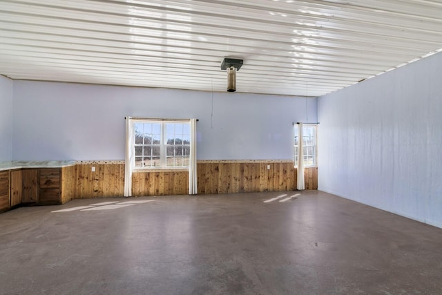 unfurnished room with plenty of natural light and concrete floors