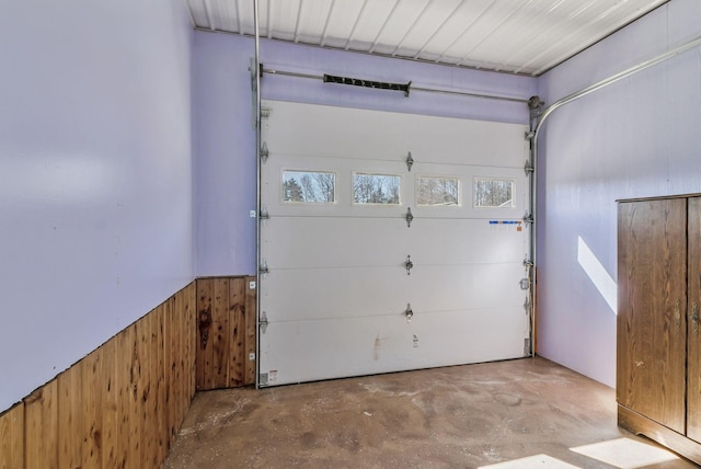 garage featuring wood walls