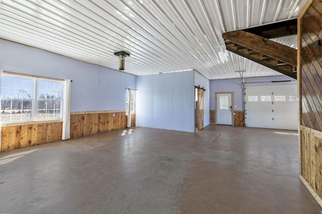 garage featuring a wainscoted wall and wood walls