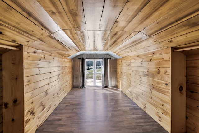 additional living space featuring lofted ceiling, wood ceiling, and wood walls