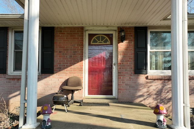 property entrance with brick siding